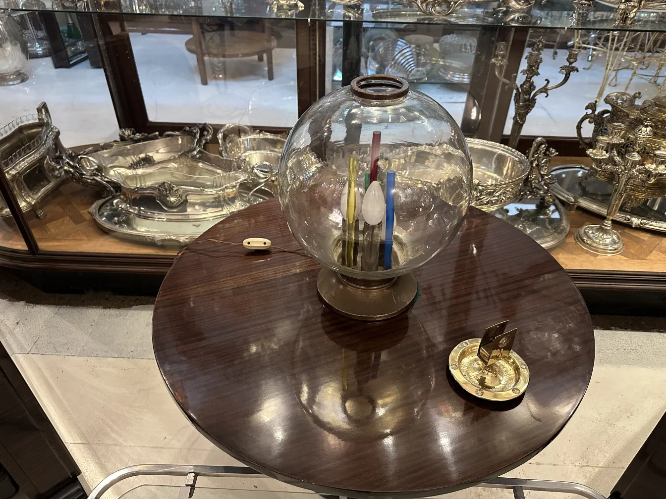 Antique WMF ashtray with decorative design and circular shape.