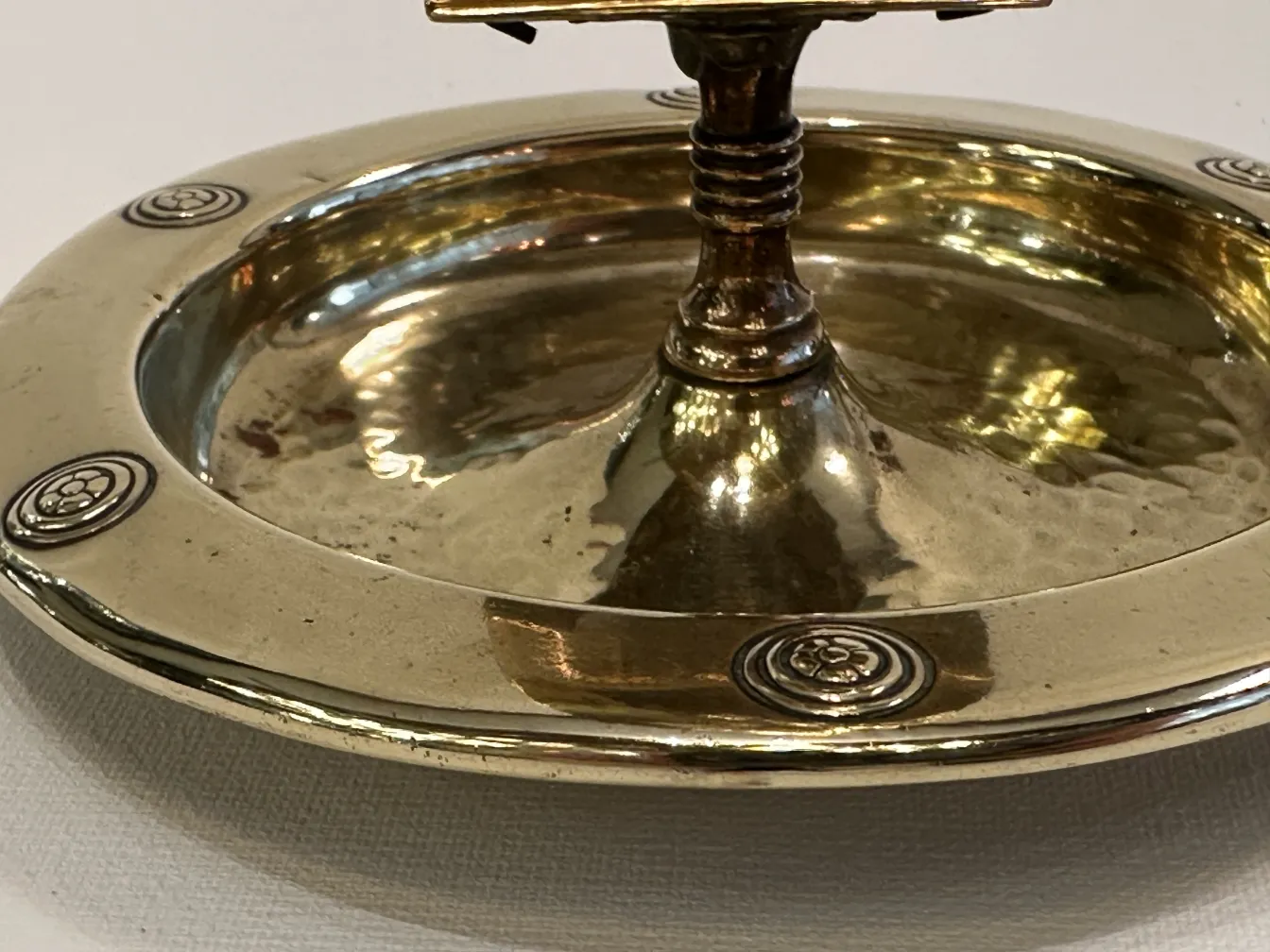 Antique WMF ashtray with decorative design and circular shape.