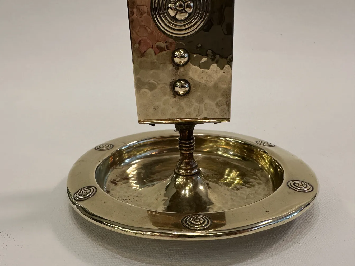 Antique WMF ashtray with decorative design and circular shape.
