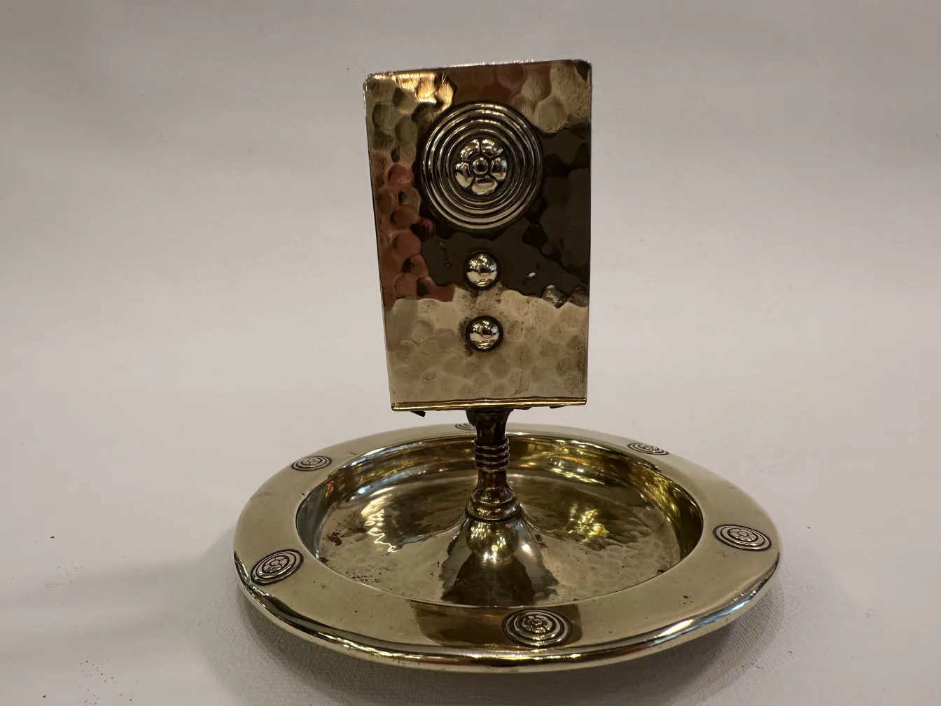 Antique WMF ashtray with decorative design and circular shape.