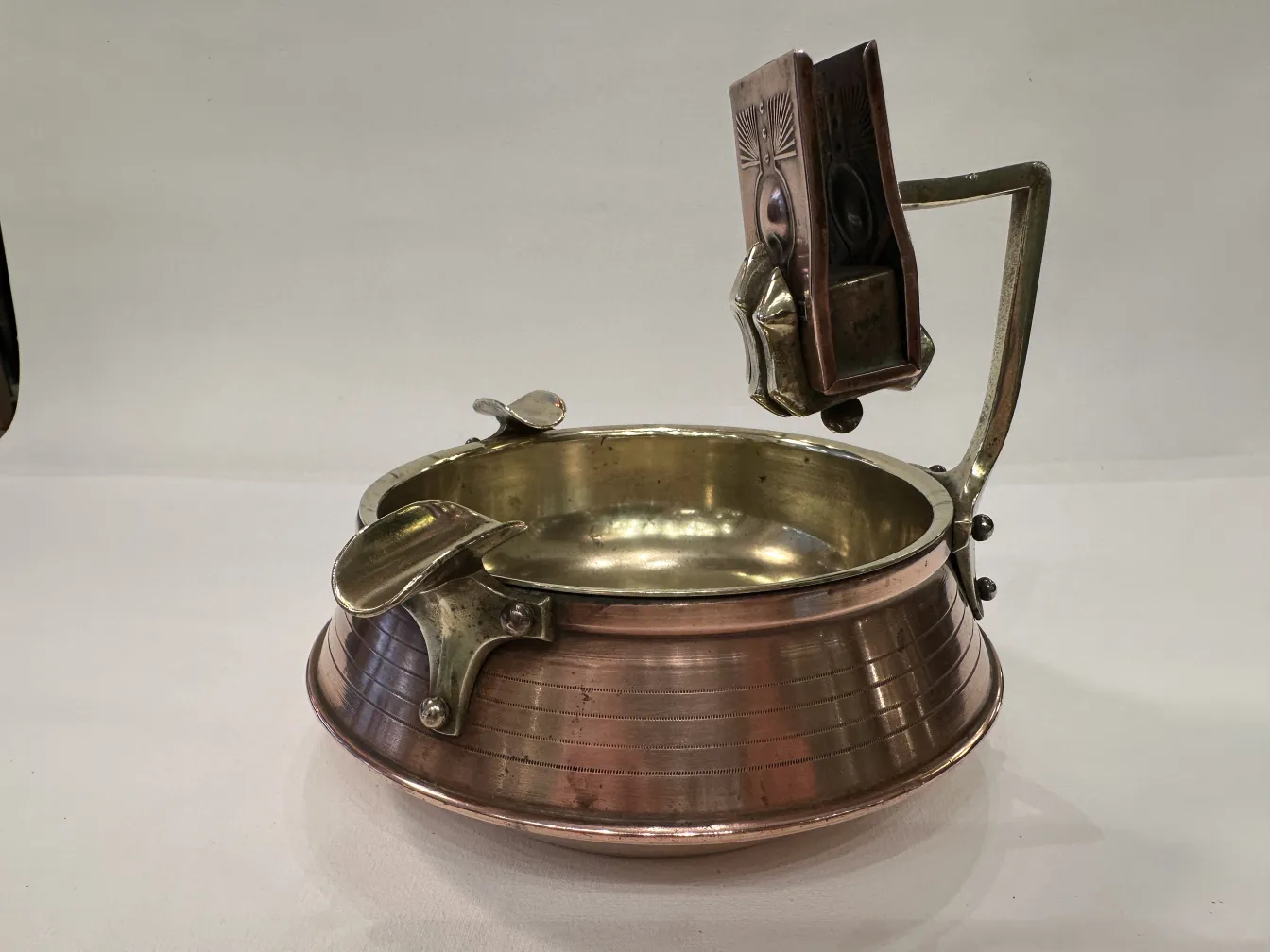 Antique ashtray on table with black surface