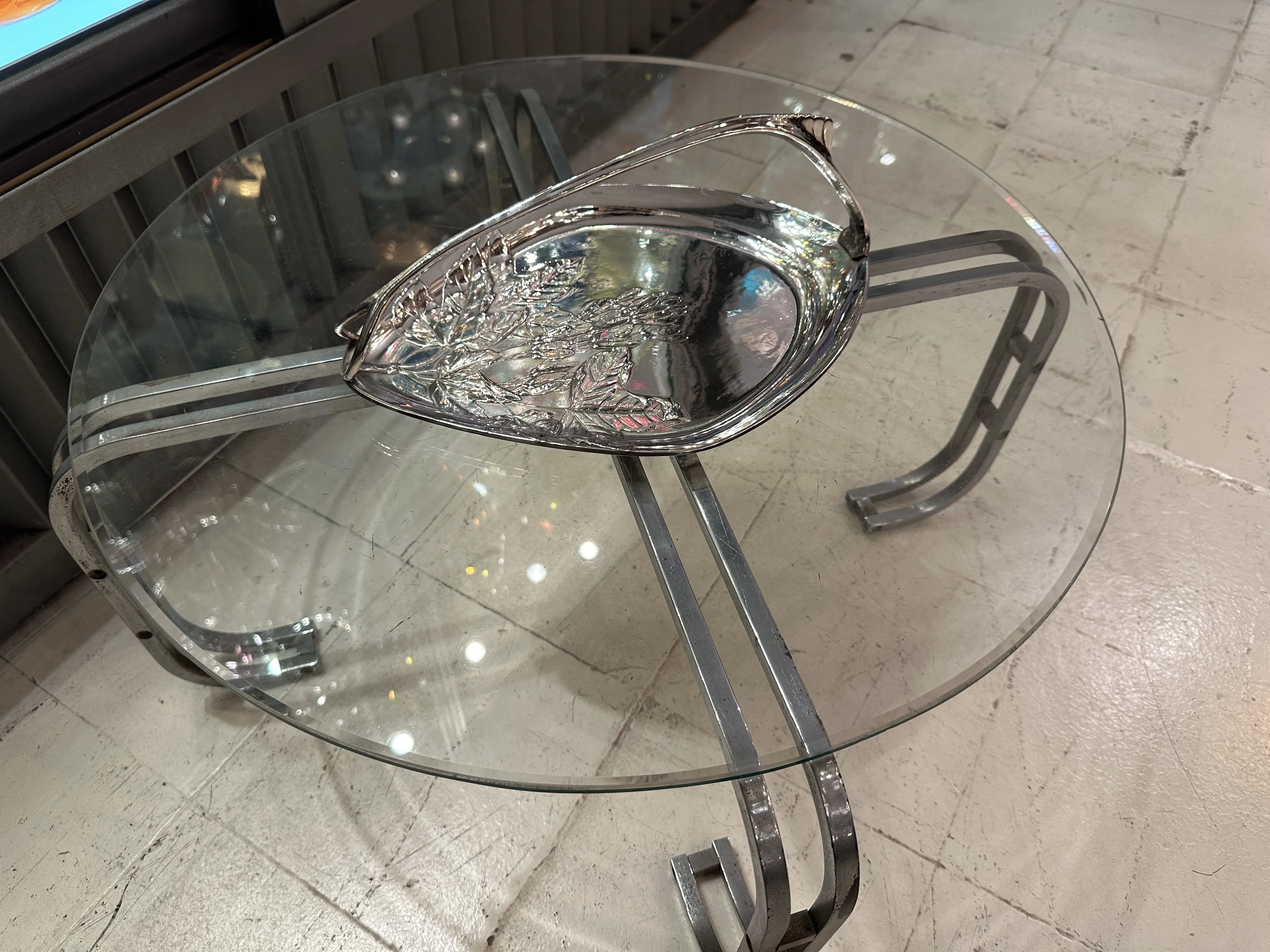 Antique card tray WMF with floral design, on glass table.