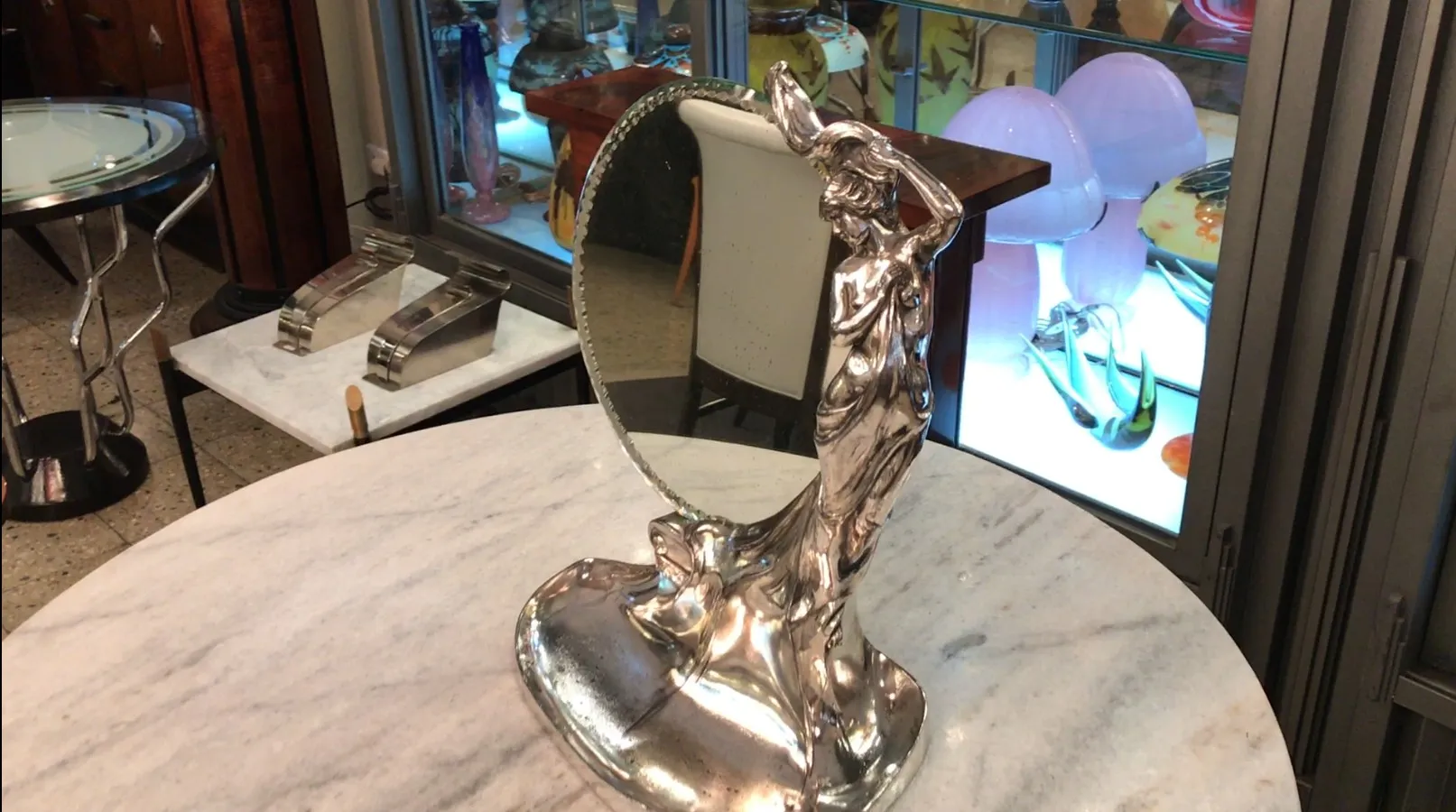 antique mirror with decorative figure support