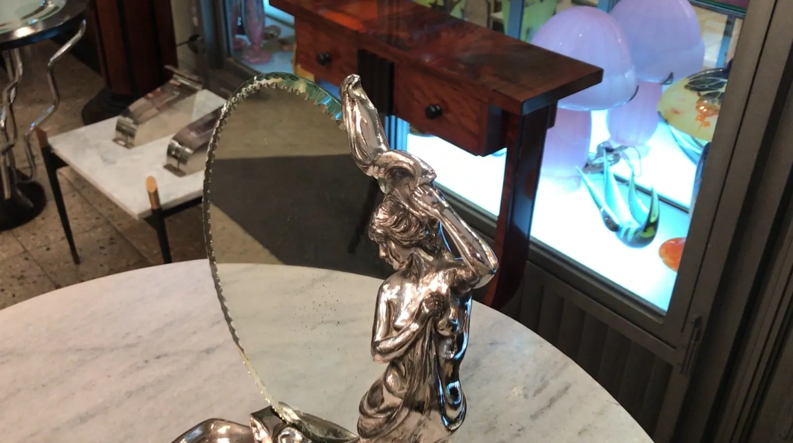 antique mirror with decorative figure, clear reflection