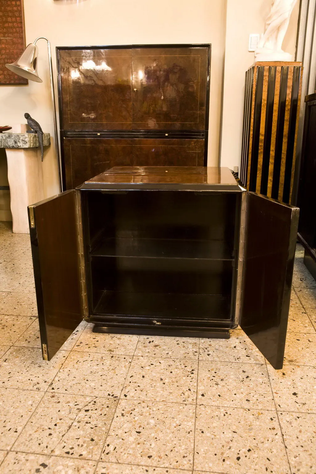 Mueble bar antiguo con puertas abiertas, fondo decorado.