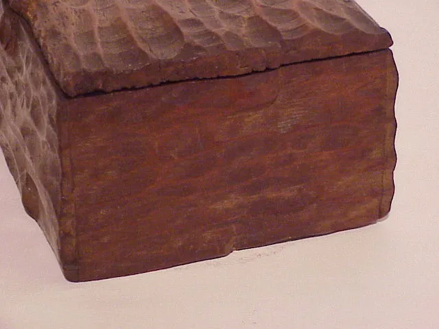 Boîte antique en bois avec texture unique et surface rustique.
