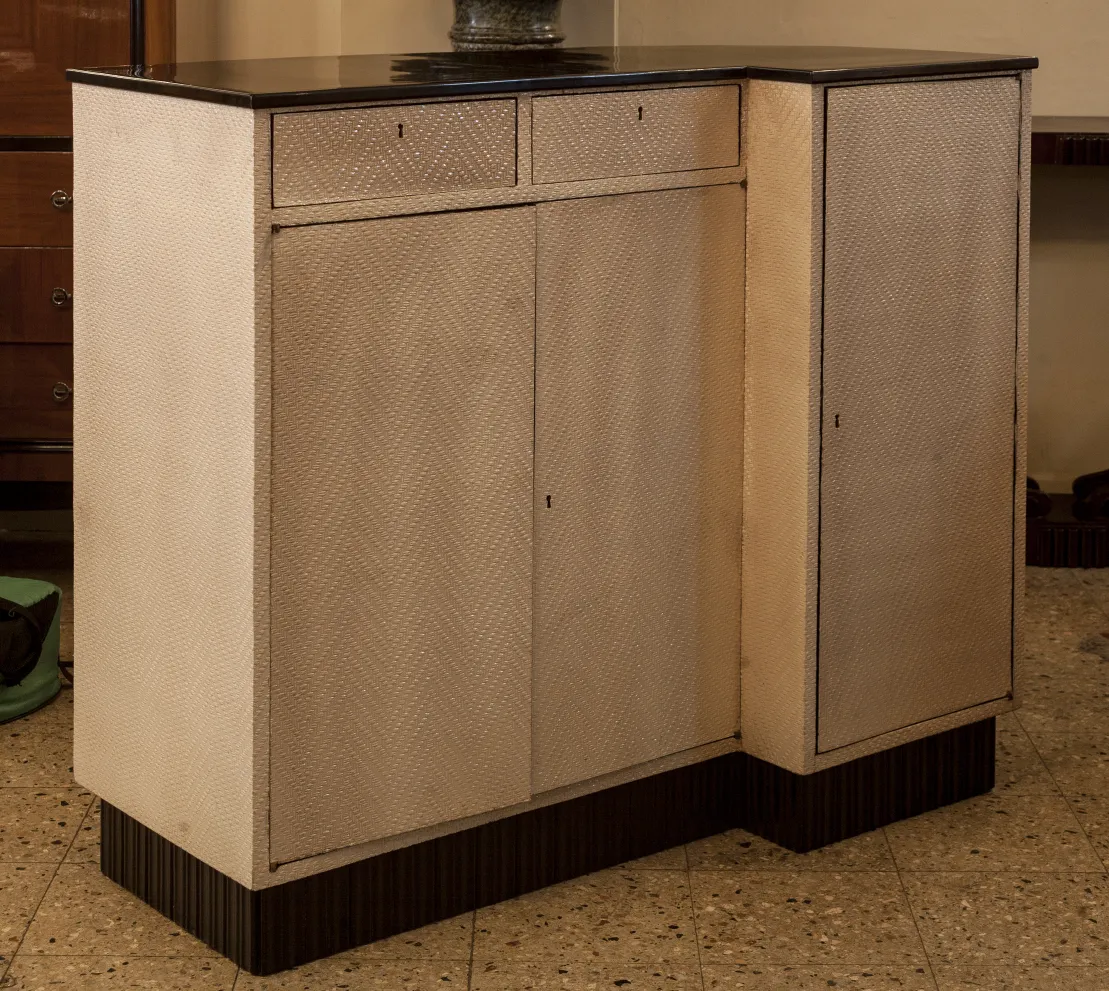 Antique bar cabinet with unique design, featuring drawers.