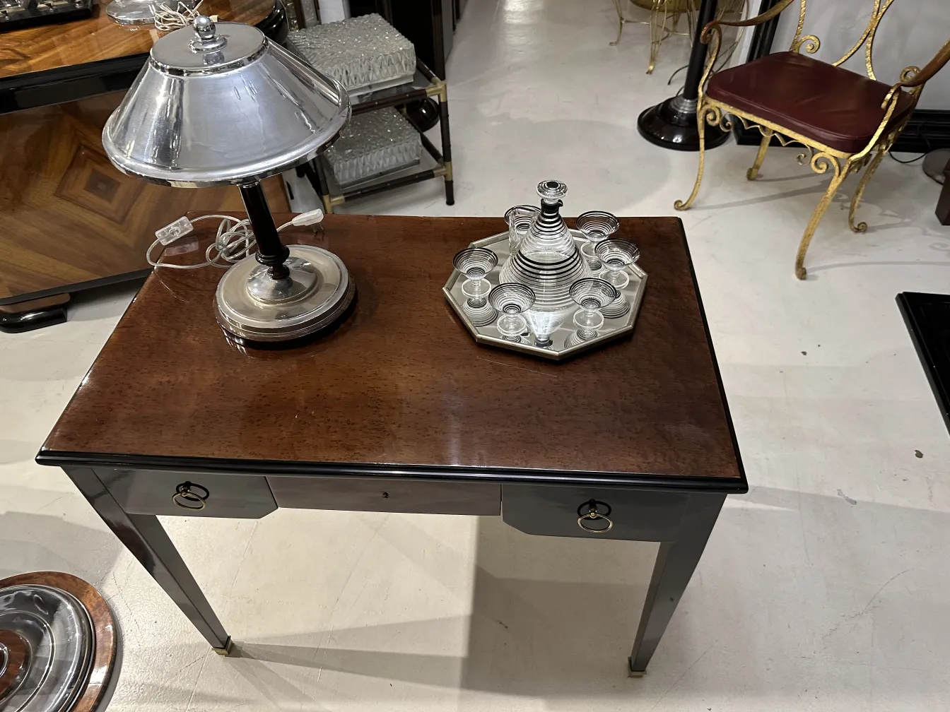 Antique liqueur set with 6 decorative glasses on a stylish table.