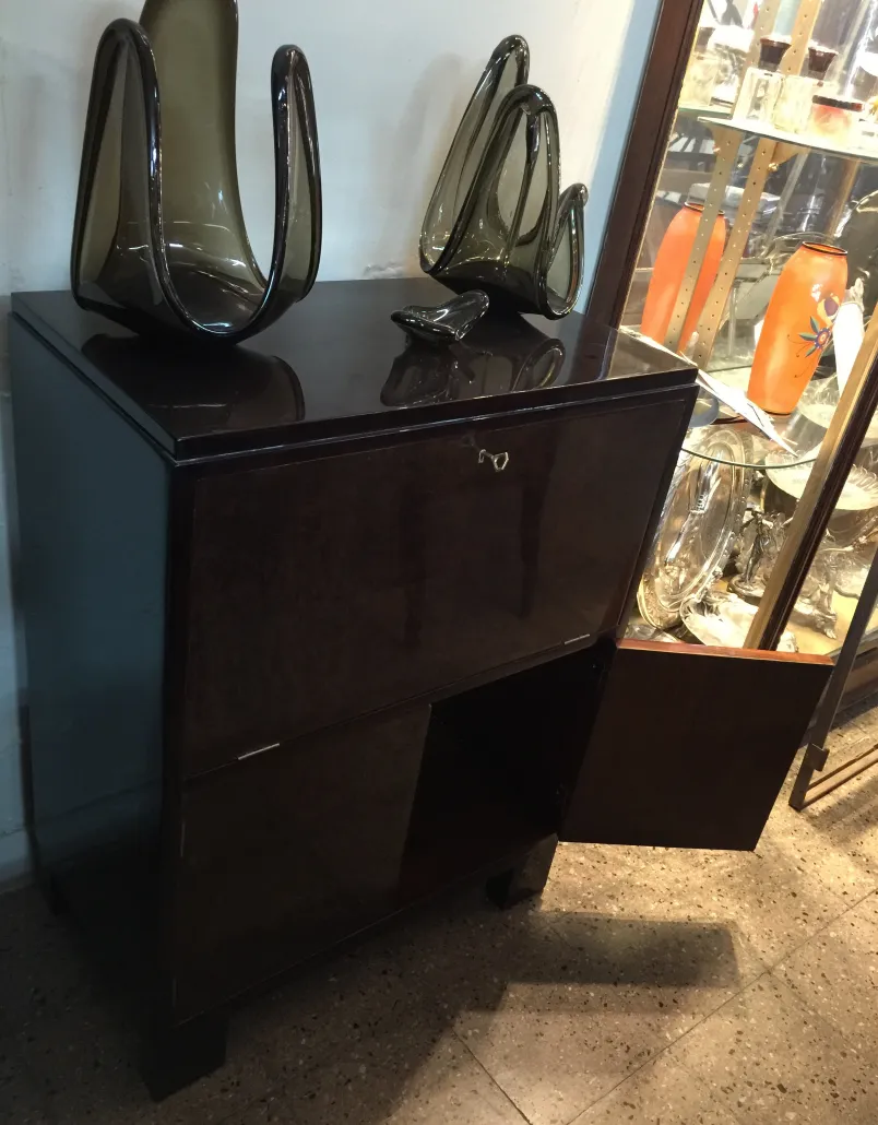 Antique compact bar cabinet with elegant decorations.