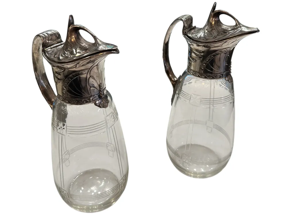 Two antique WMF jars featuring decorative details and an elegant design in a classic setting.