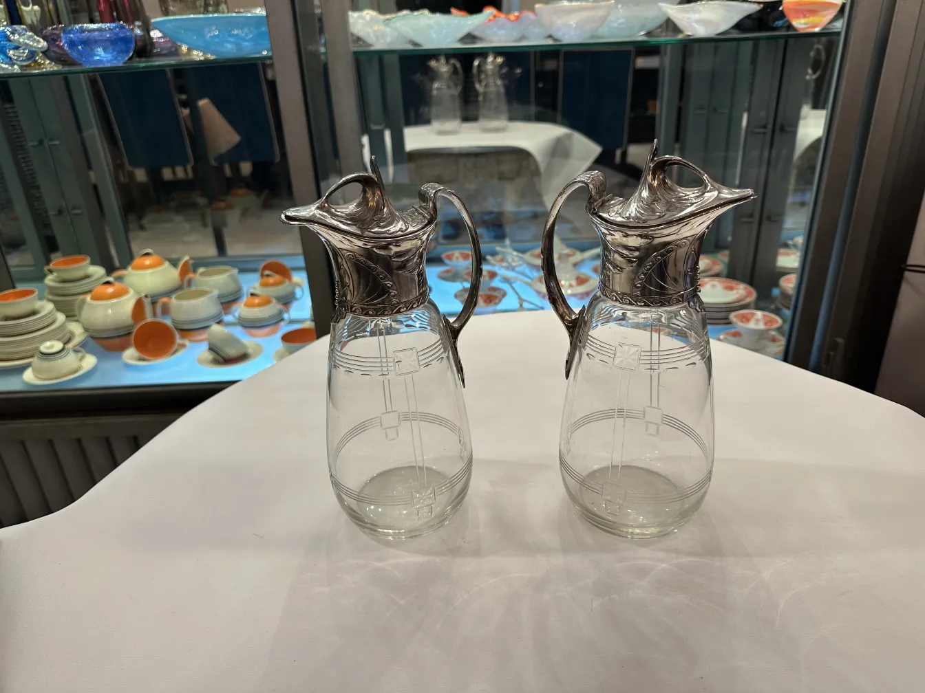 Two antique WMF jars featuring decorative details and an elegant design in a classic setting.