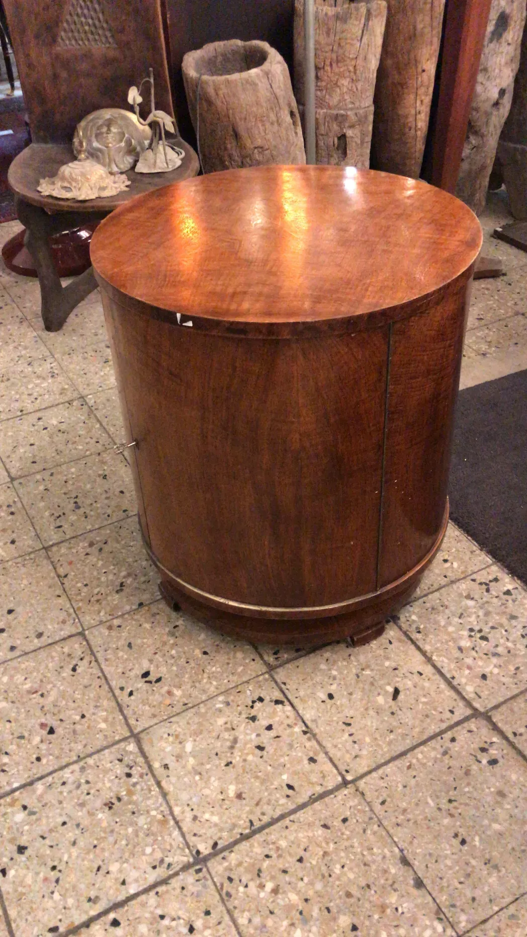 Antique bar with a rounded top, surrounded by decorative items.