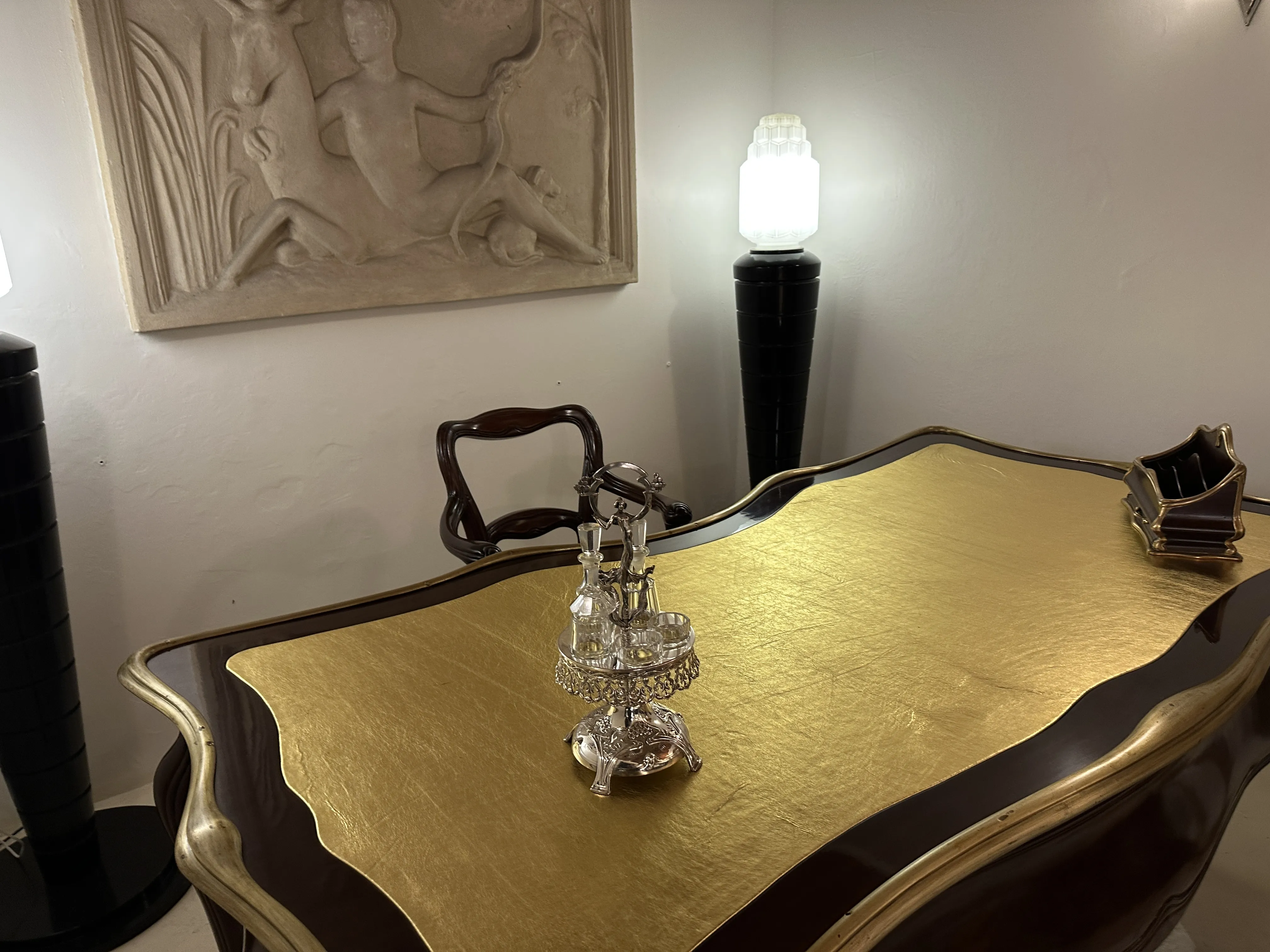 Antigo saleiro e pimenteiro com azeite e vinagre da WMF em uma mesa ornamentada.