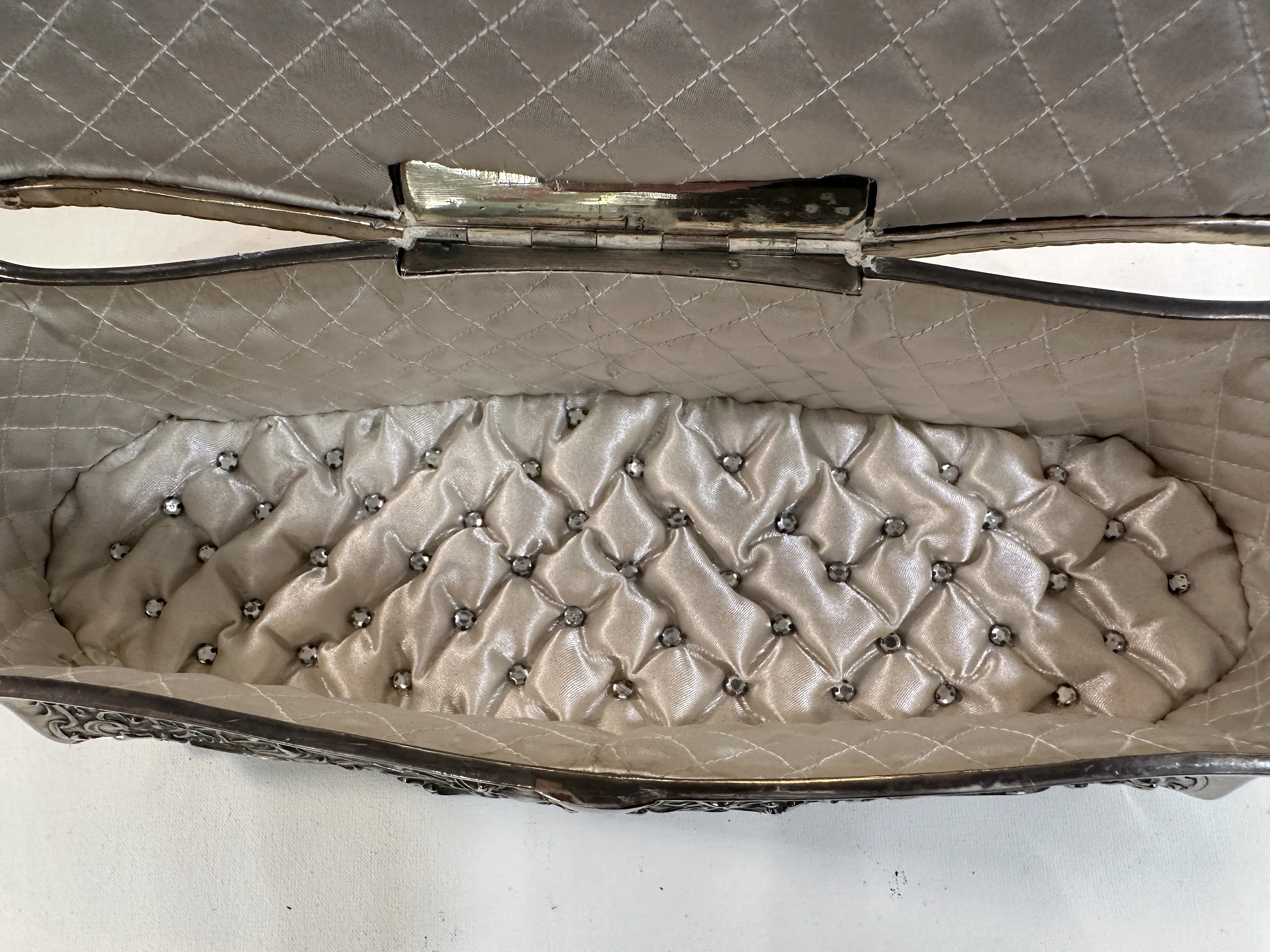 Interior of an antique box with fabric details and embellishments