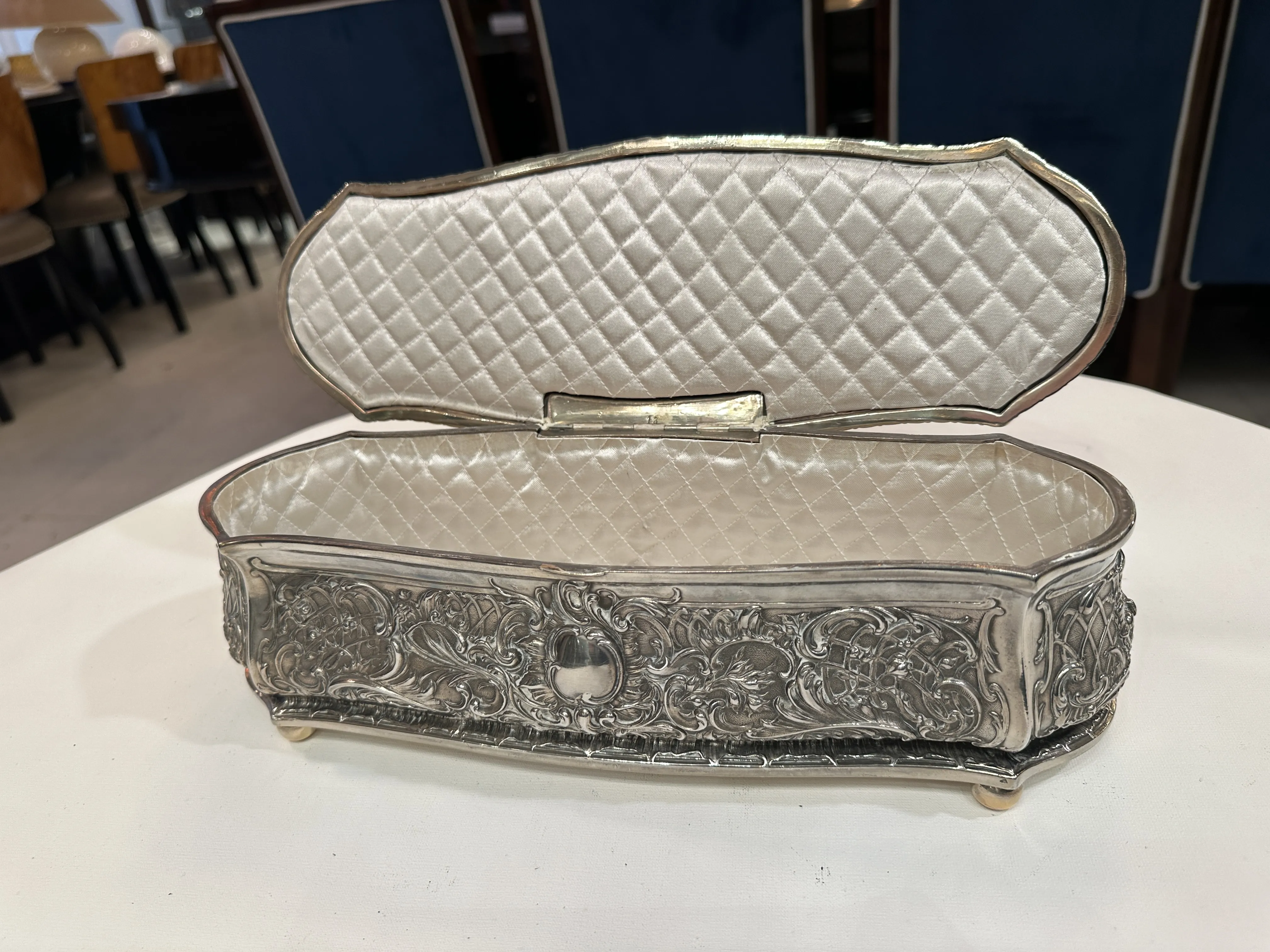 Antique box featuring ornate details and a padded interior
