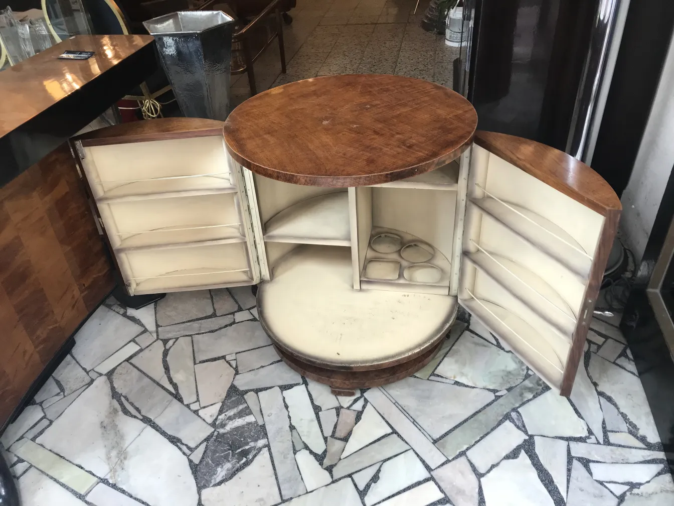 Mobile bar antico con porte e ripiani in un ambiente elegante.