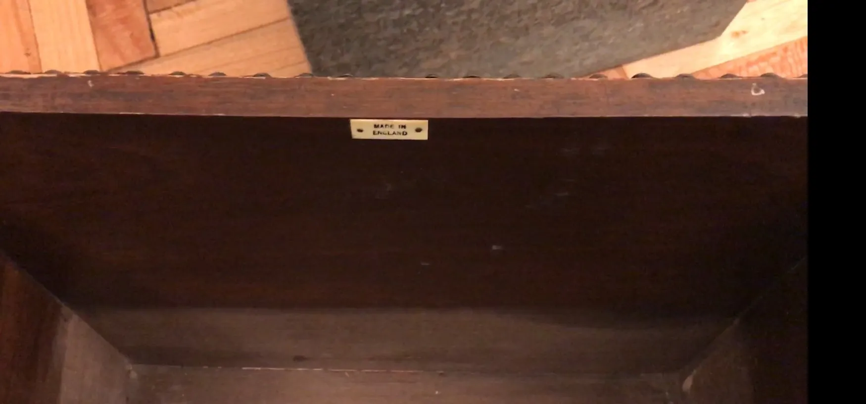 Antique bar with a label showing made in England, dark interior.