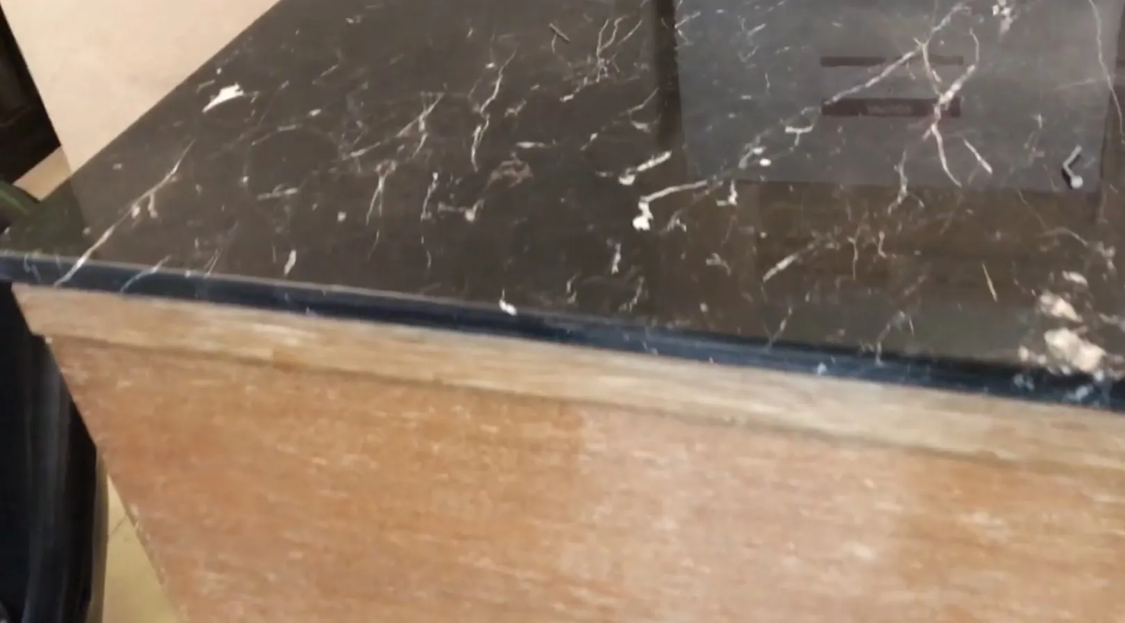 Antique bar cabinet with a marble top, warm ambiance.