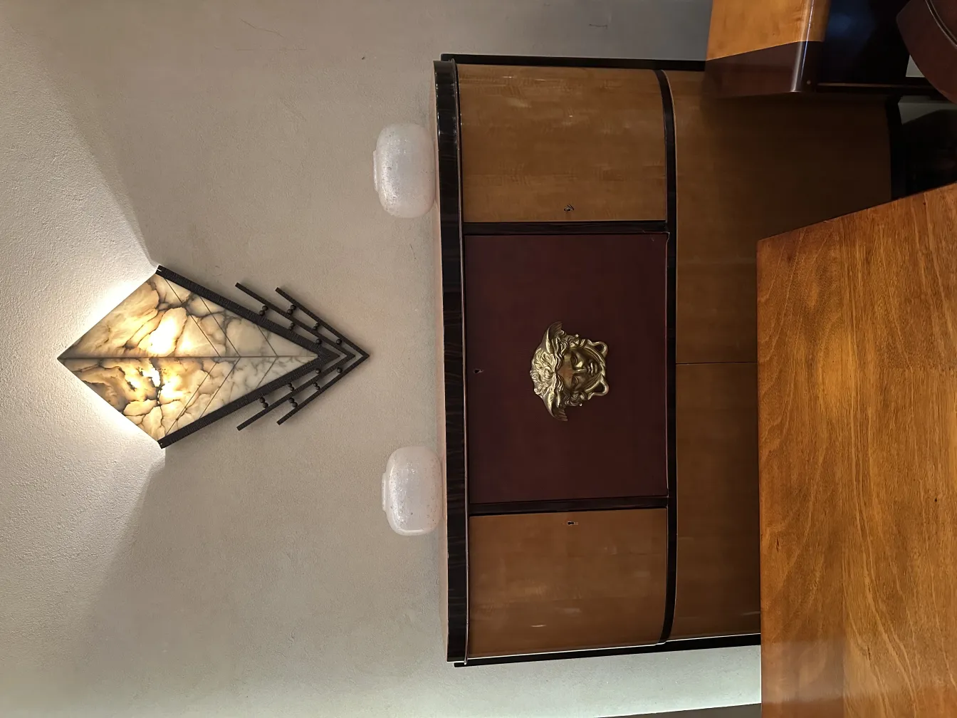 Pair of antique sconces with soft light on the wall.