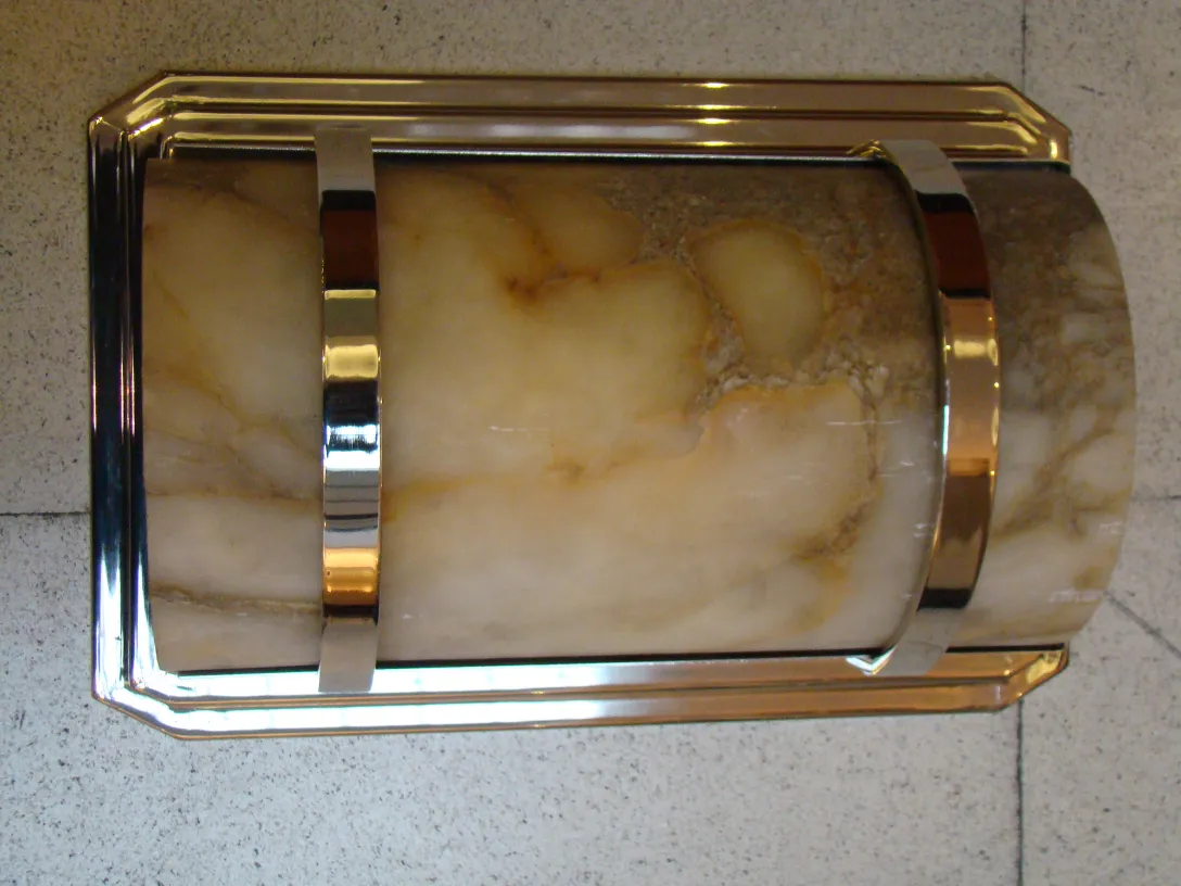 Luminárias de parede antigas com detalhes dourados em ambiente elegante, ideais para decoração.