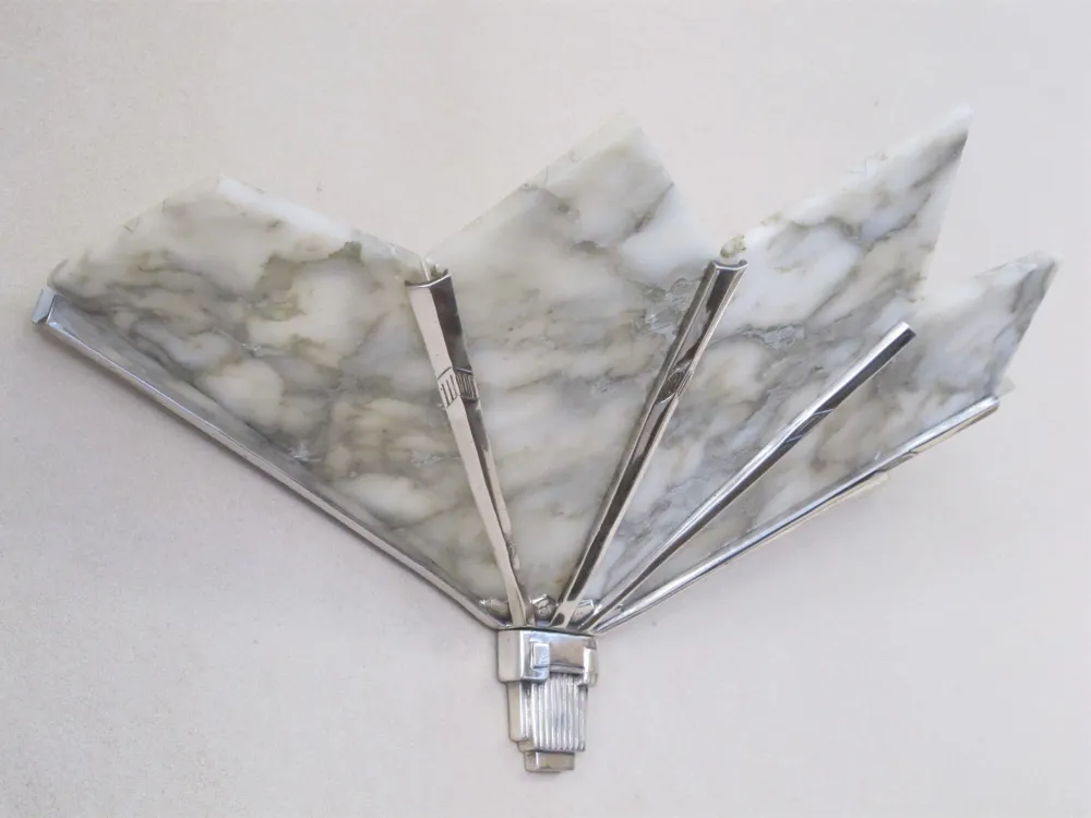 Antique pair of sconces with elegant design and geometric shapes.