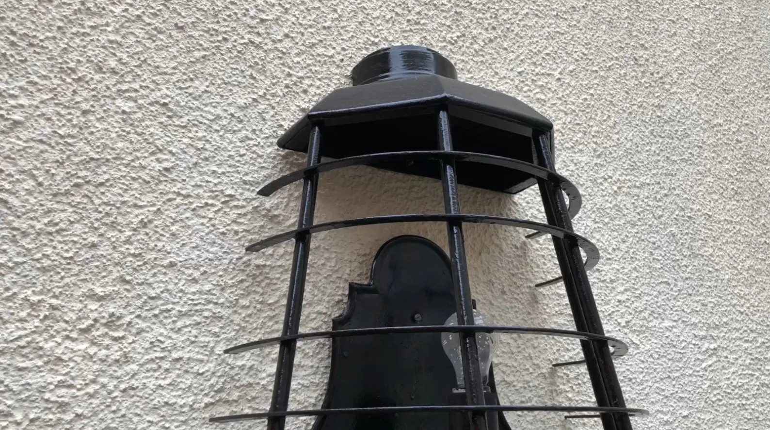 Antique sconces with a black grid design.