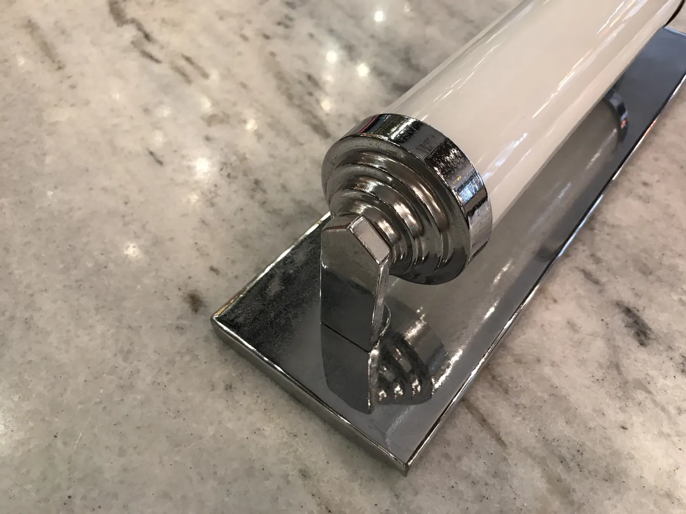 Antique pair of sconces with shiny base on marble