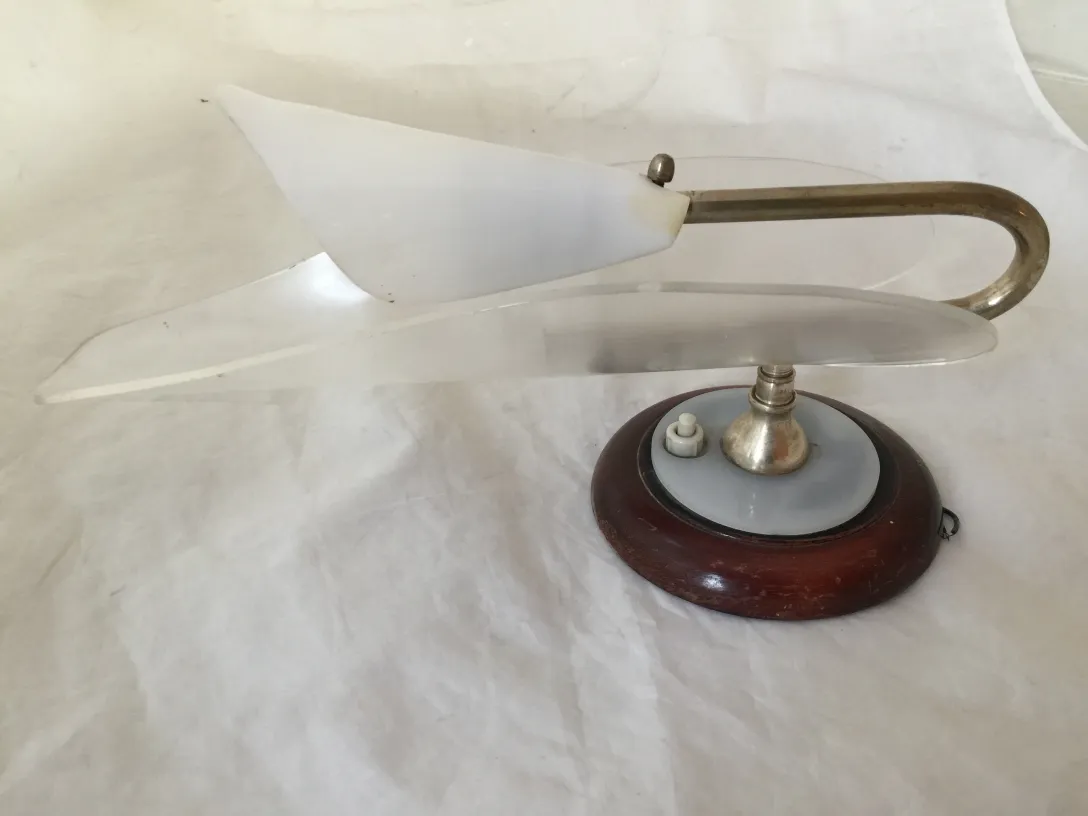 Elegant antique sconces with transparent acrylic shades and round base.