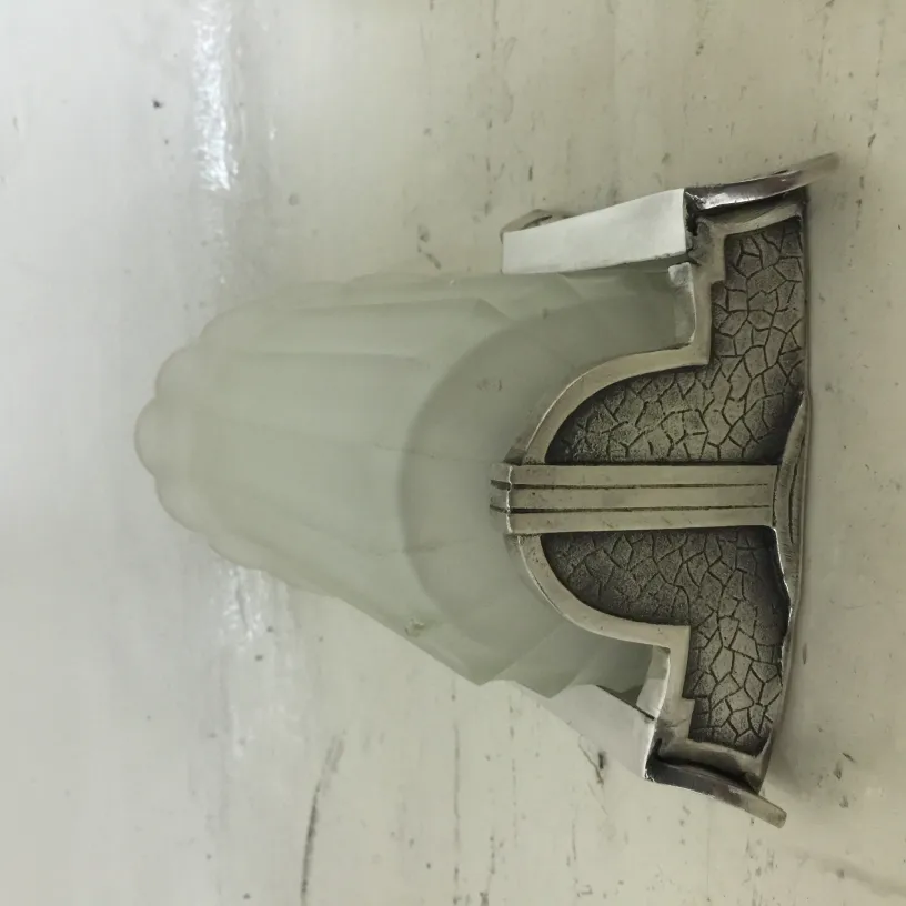 Pair of antique sconces featuring an elegant design with frosted glass.
