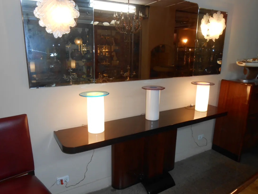 Par de luminárias antigas sobre uma mesa, iluminando o ambiente