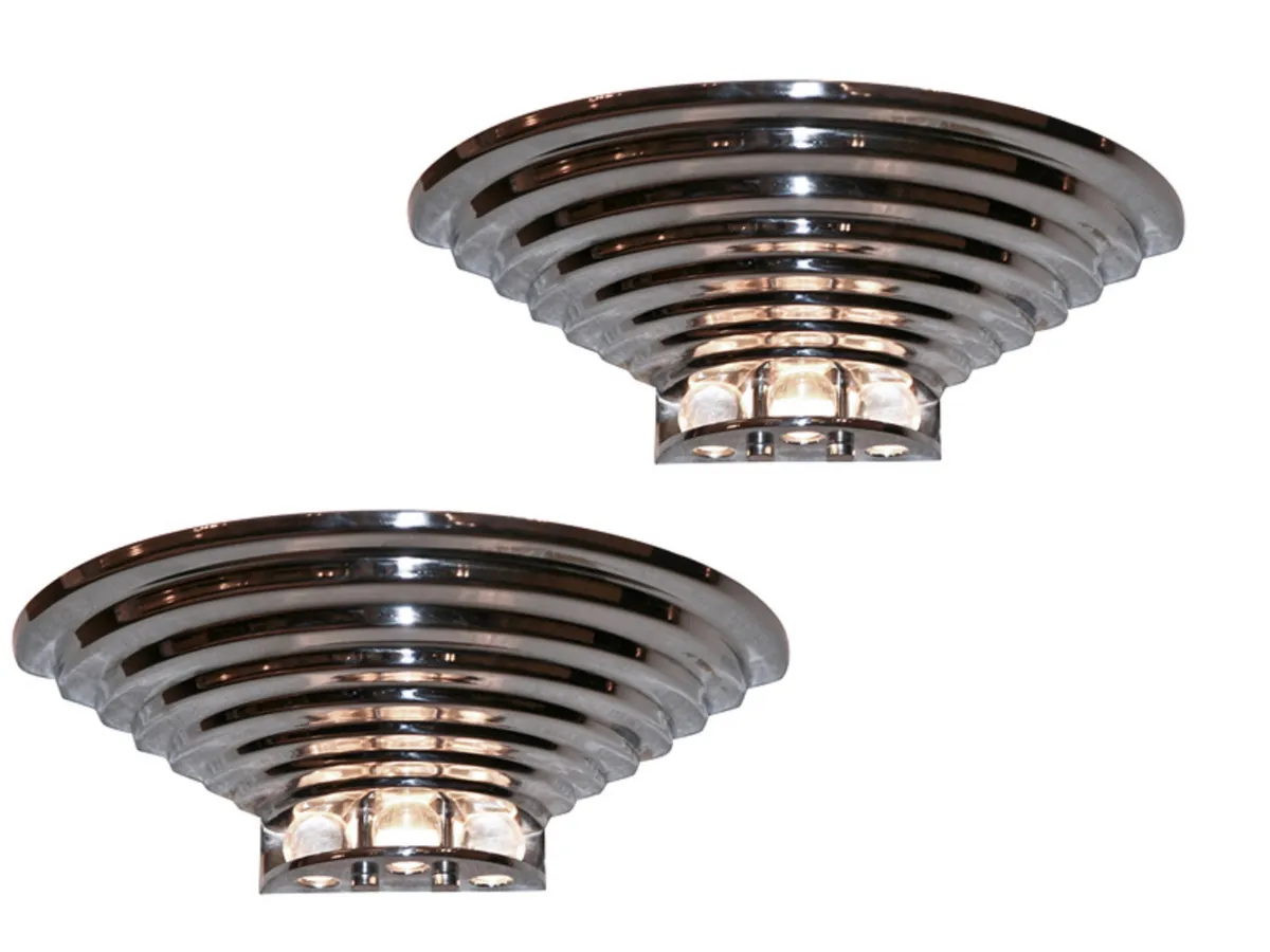Pair of antique sconces featuring a contemporary and elegant design.