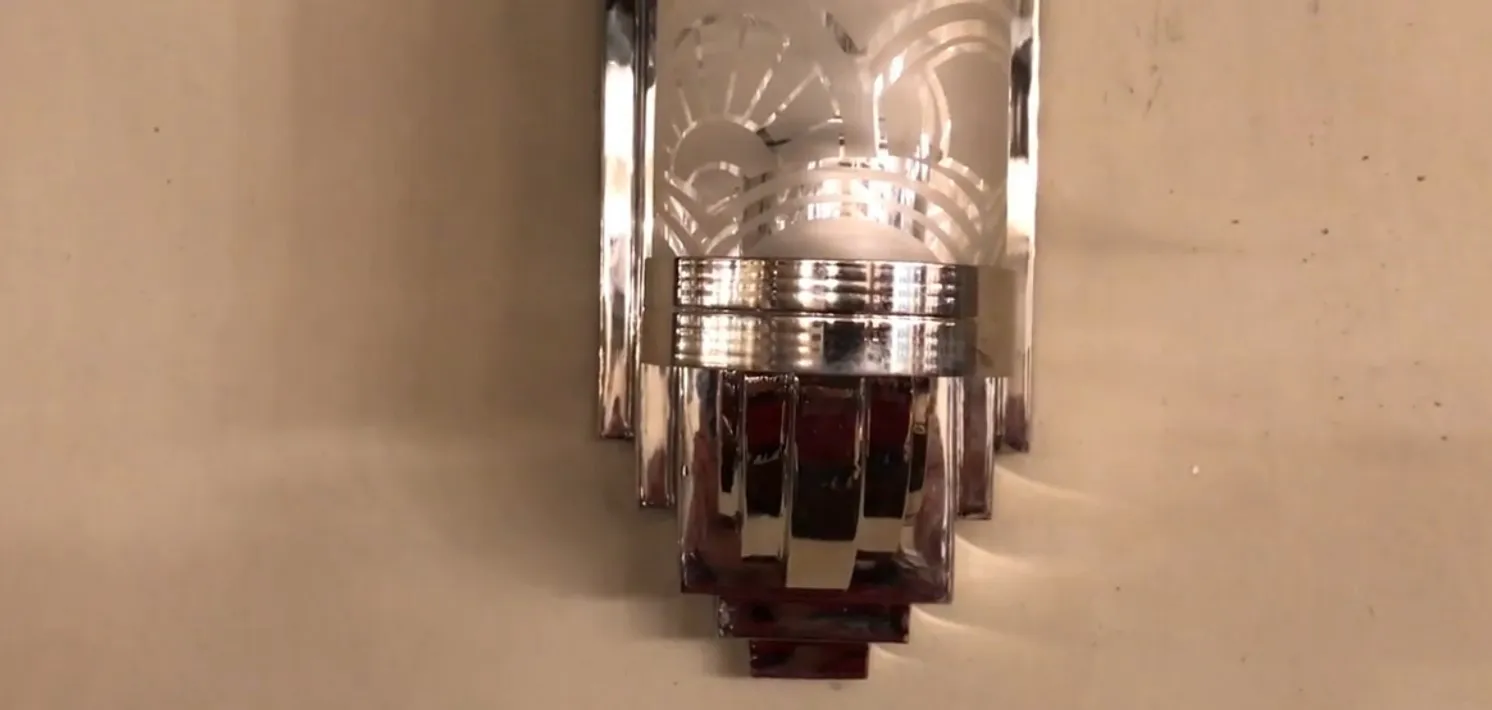 Pair of antique sconces with elegant crystal and metal design