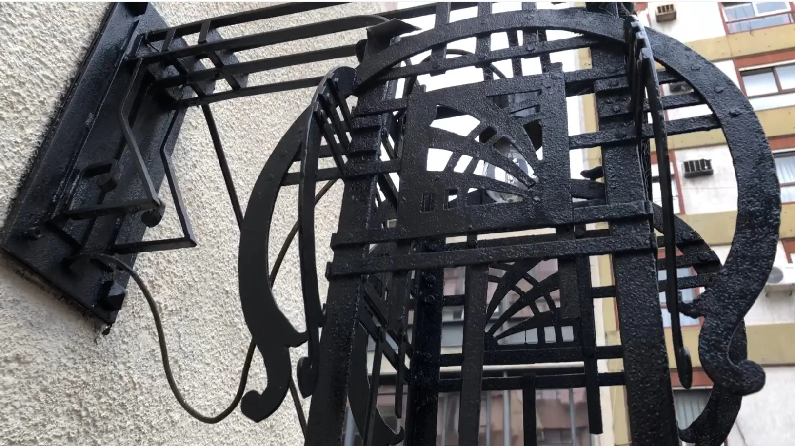 Pair of antique black wall sconces with artistic design