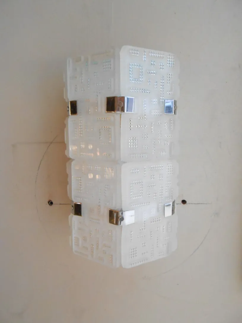 Antique pair of sconces with a geometric white and metal design