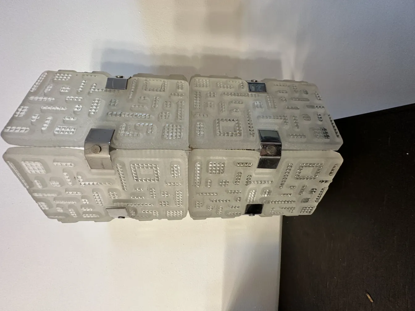 Coppia di applique antiche con design decorativo unico in elegante colore bianco. Atmosfera di illuminazione soffusa.