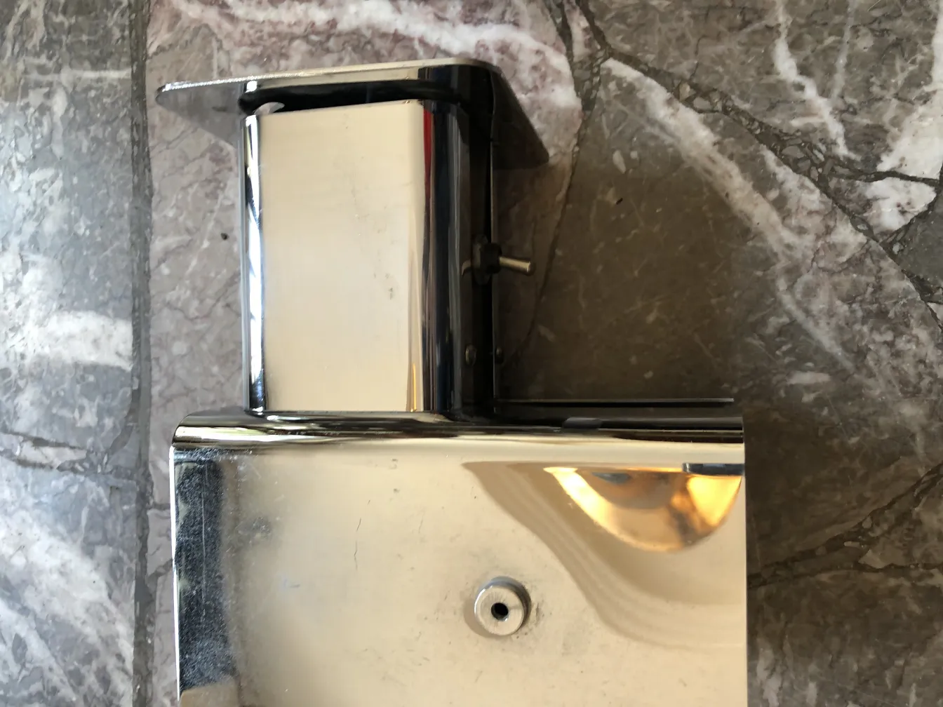 Pair of shiny antique sconces with elegant design, in a classic setting.