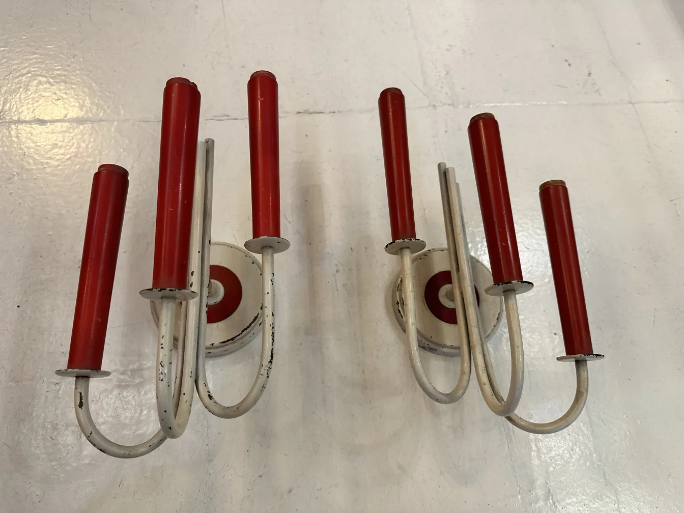 Antique sconces featuring Jean Royère design, with red and white colors, perfect for vintage decor.