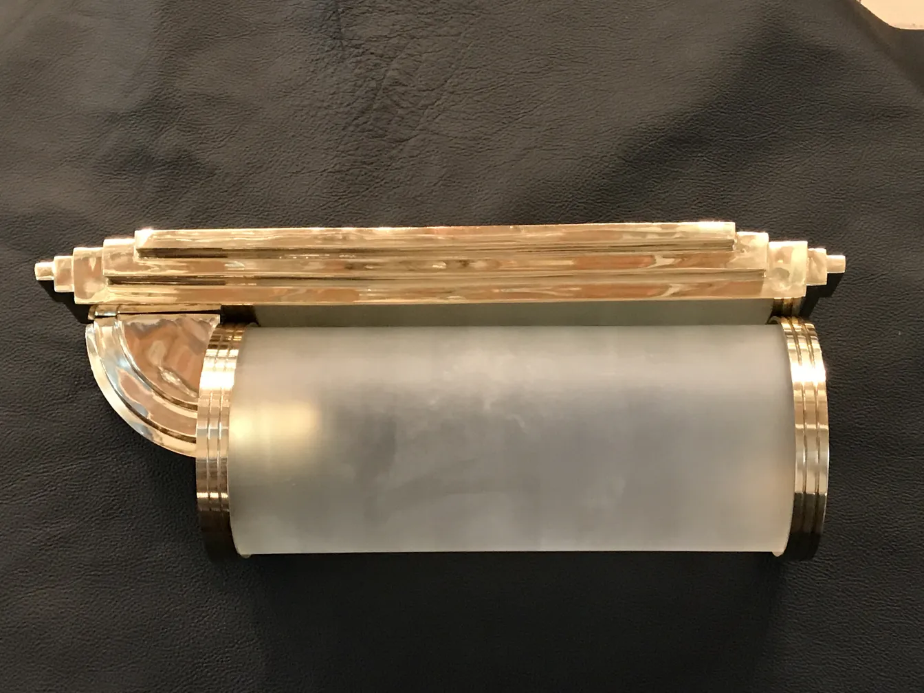 Beautiful pair of antique sconces featuring elegant gold and white design.