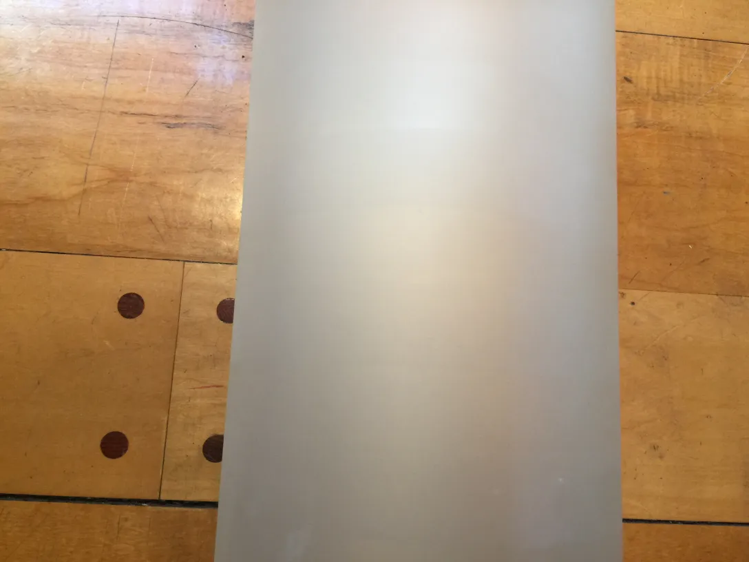 Antique pair of sconces with elegant design against light wood background