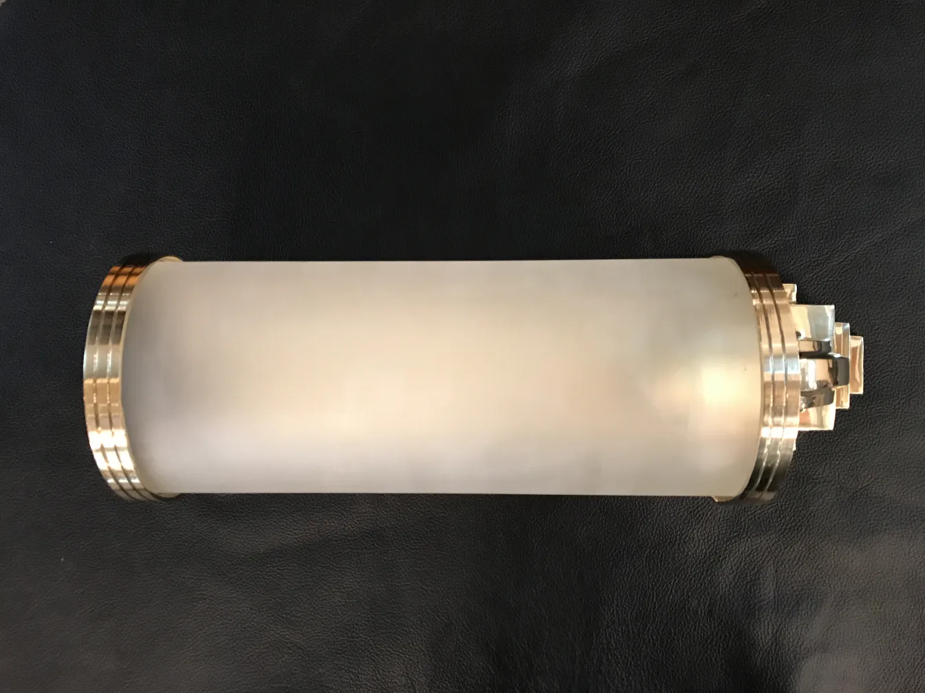 Antique pair of sconces with golden details, stylish and functional against a dark background.