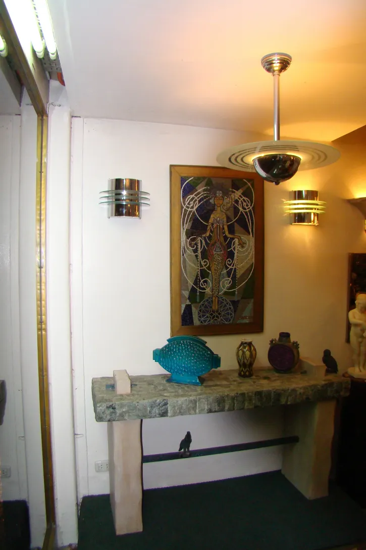 Antique pair of metal sconces with soft light on white wall