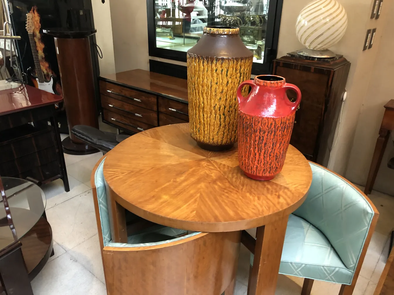 two antique ceramic vases in vibrant colors on a table