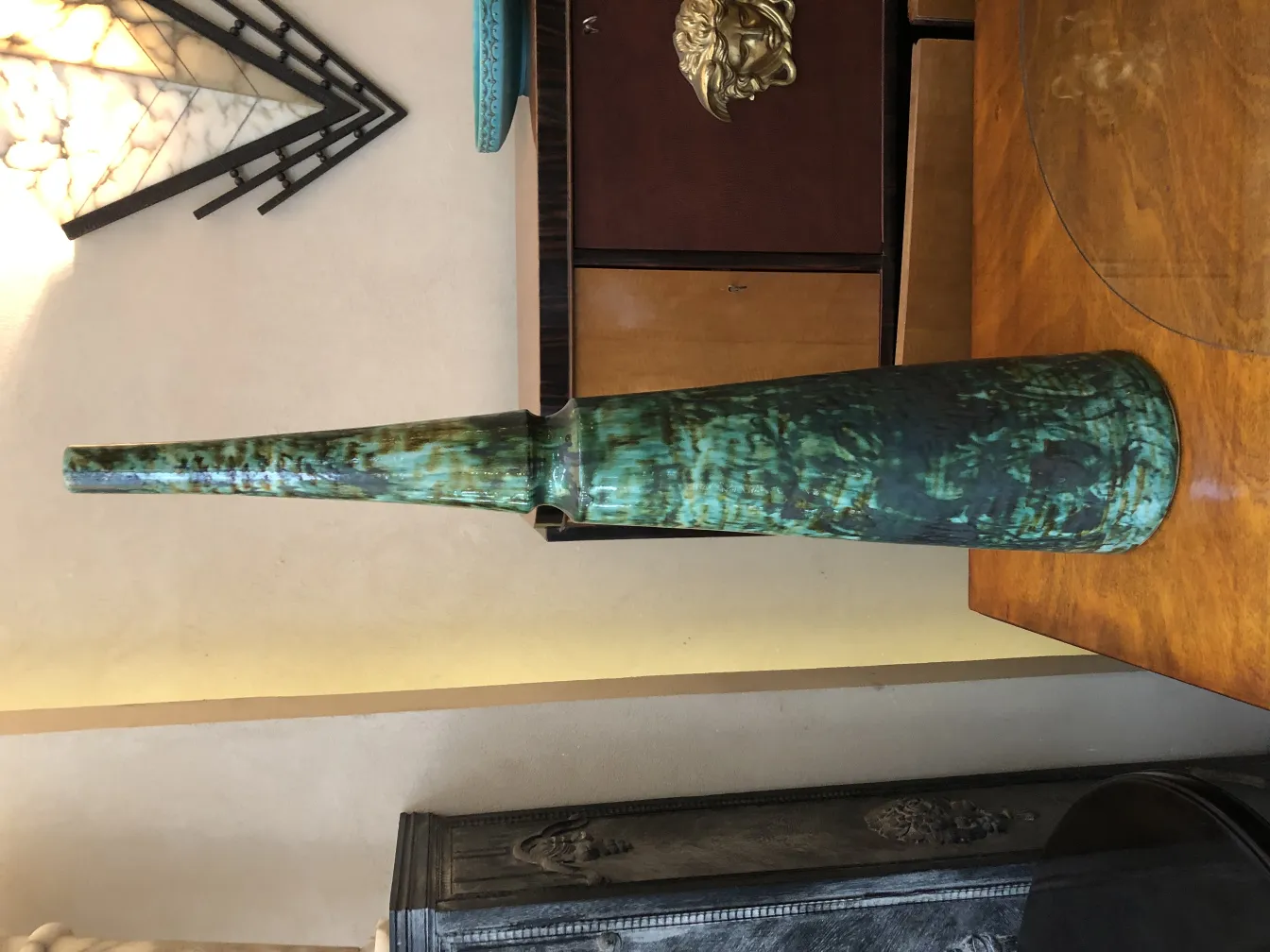 Antique ceramic vase, vibrant green color, elegant elongated shape.