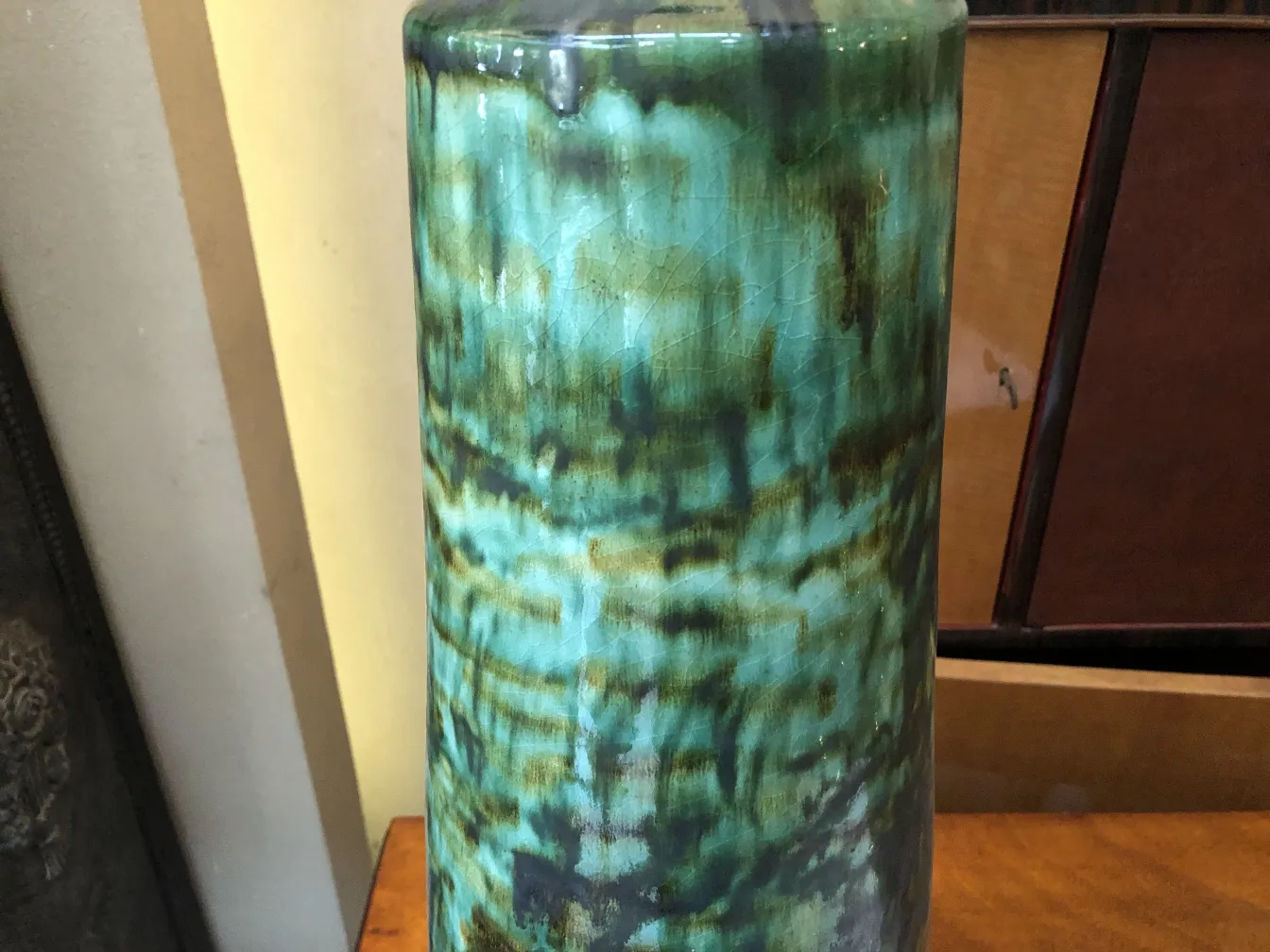 Antique ceramic vase in green and blue tones with unique texture