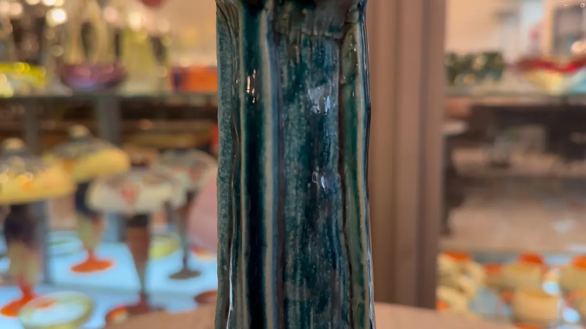 Antique green ceramic vase with decorative details