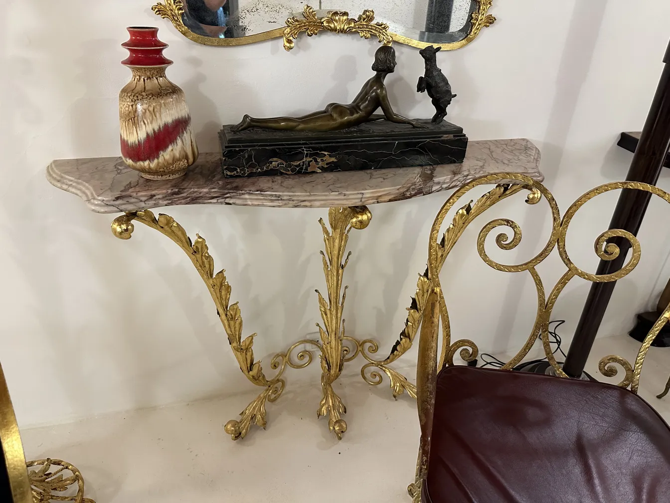 Antique ceramic vase with brown and red tones on a decorative table.
