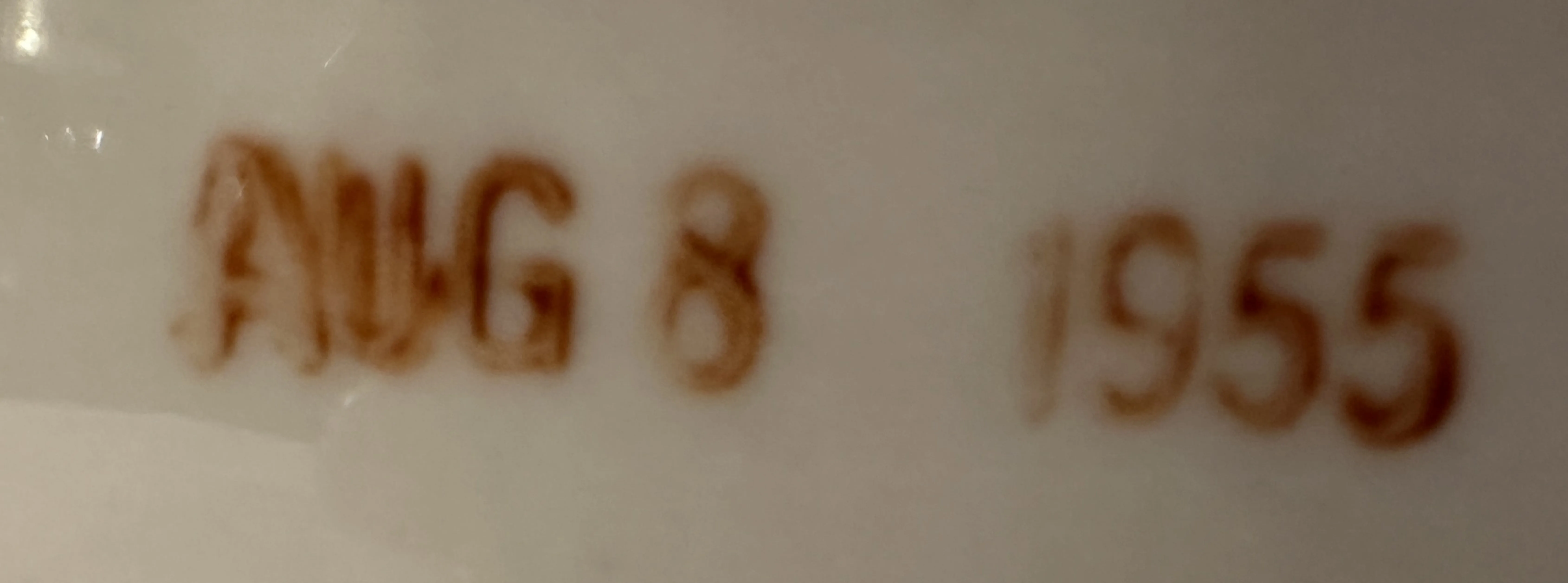 sello antiguo con fecha aug 8 1955, textura clara, contexto de antigüedades