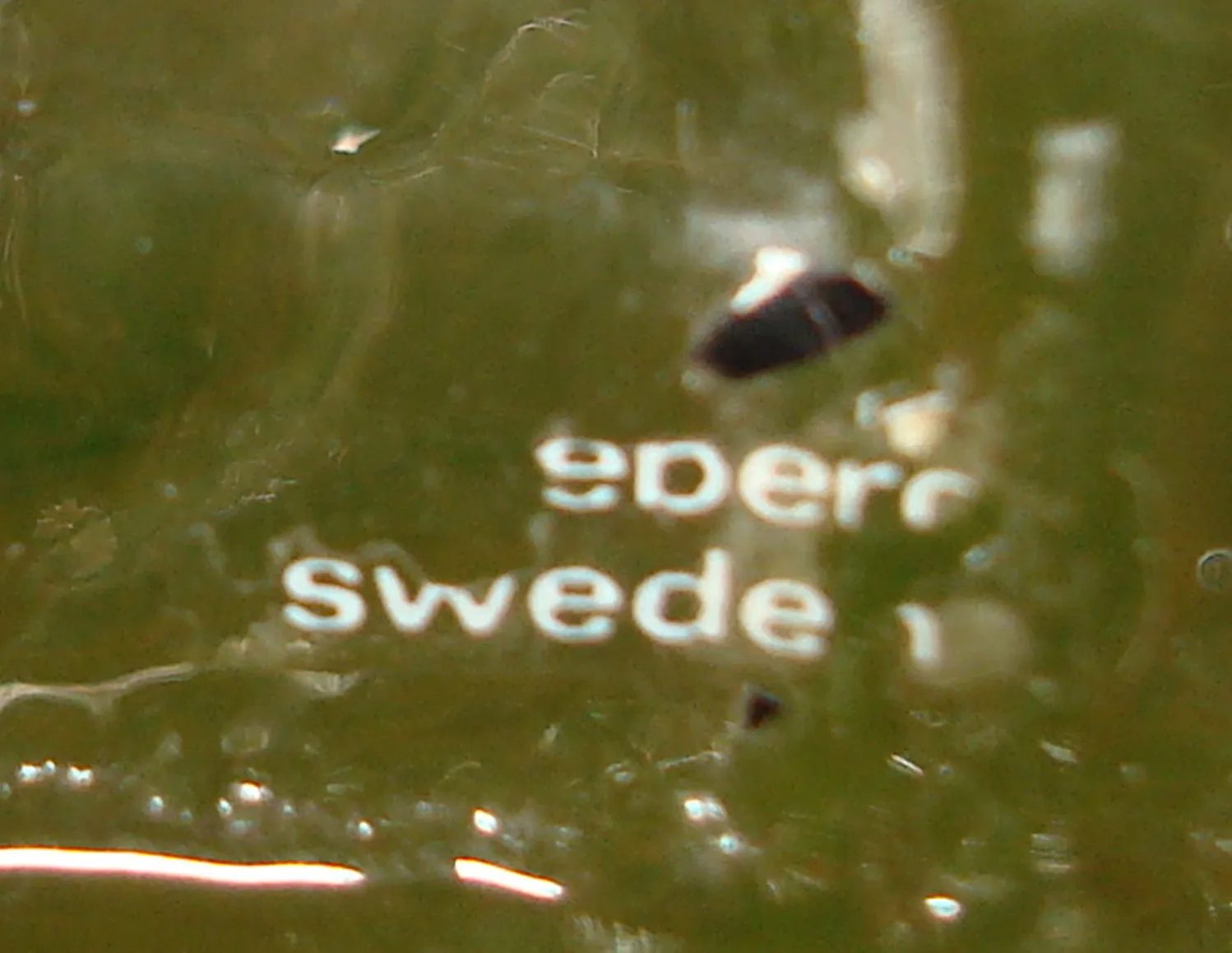 पुराना मुद्रण जिसमें Pukeberg Sweden है, हरा पृष्ठभूमि